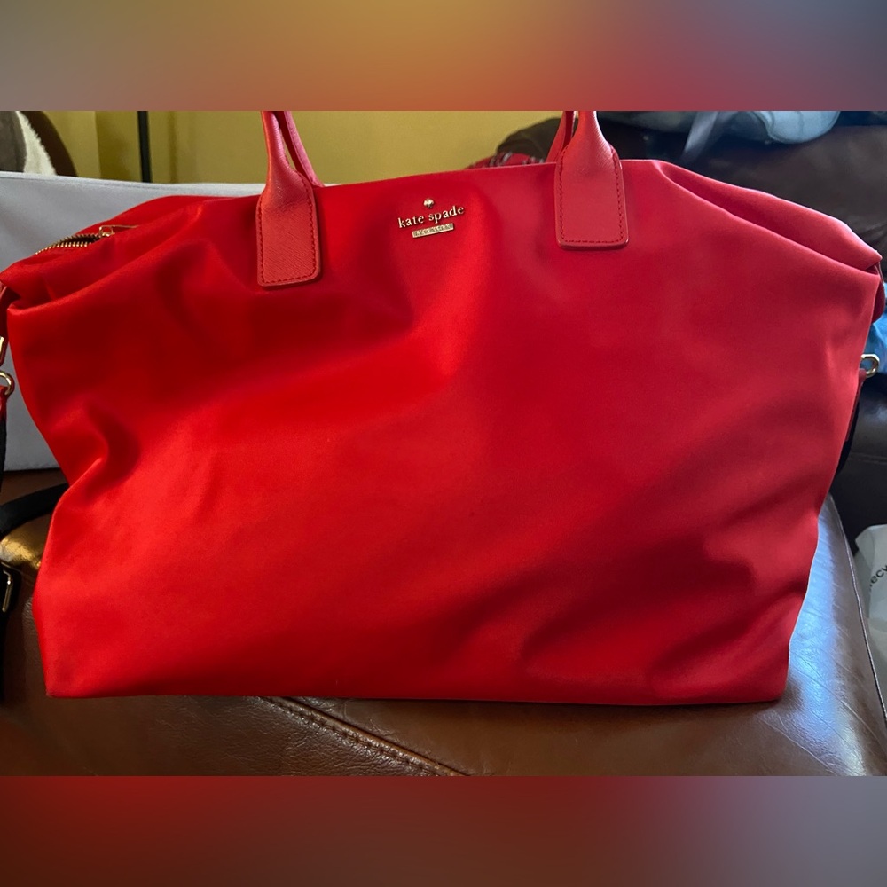 Kate Spade nylon tote bag with adju shoulder strap, leather trim, zip top.